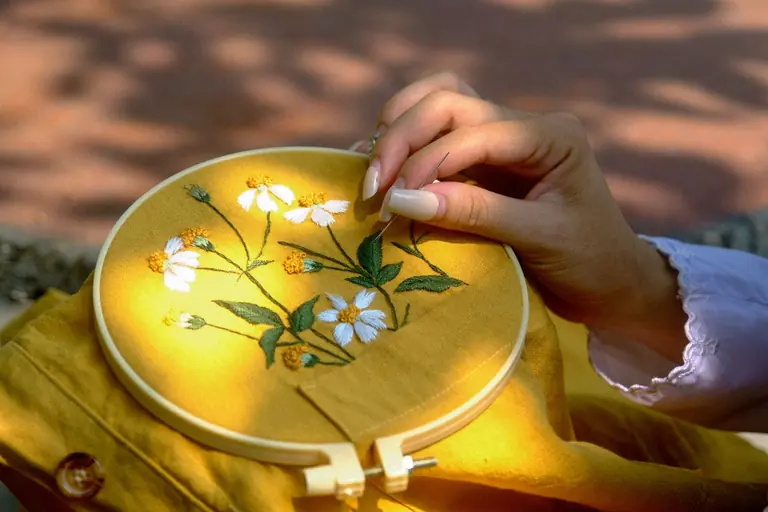 Beautiful hand embroidery of flowers in sunlit Hue, Vietnam.